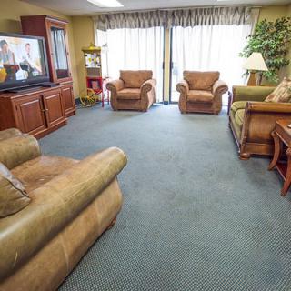 A cozy living room with comfortable seating and a television.