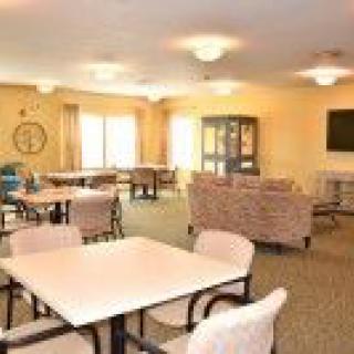 A bright and spacious lounge area with tables and chairs.