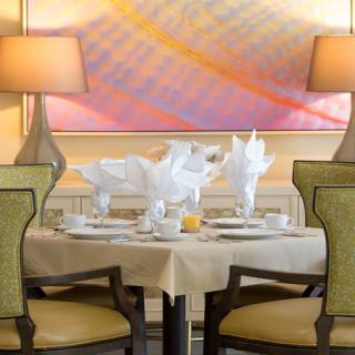 Elegant dining table setup with stylish decor and warm lighting.