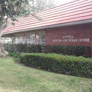 Exterior view of a health and wellness center featuring a red roof and landscaped surroundings.