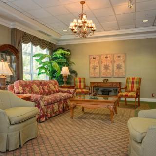A cozy traditional living room with elegant furniture and warm lighting.