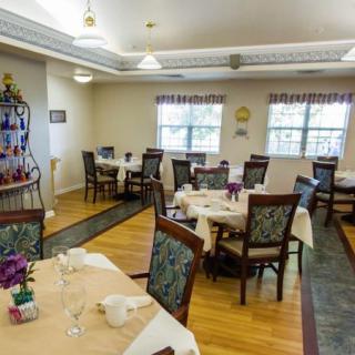 An inviting dining room with elegantly set tables and comfortable chairs.
