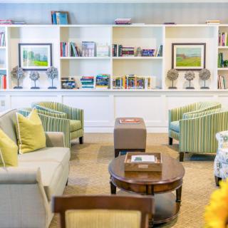 A cozy living room with comfortable seating and bookshelves.