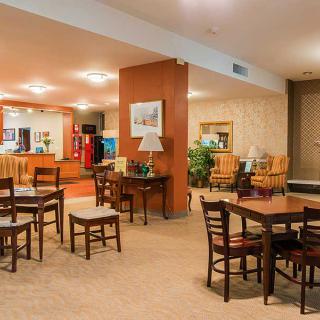 A cozy hotel lobby with a seating area and reception desk.