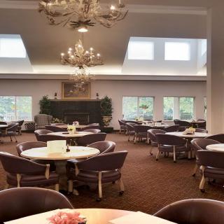 Spacious dining area with elegant chandeliers and large windows.