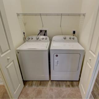 A compact laundry area with a washing machine and dryer side by side.