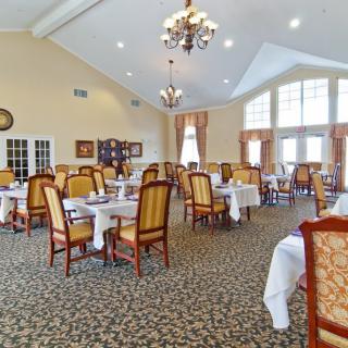 A spacious dining room with elegant decor and neatly arranged tables and chairs.