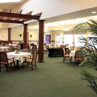 Spacious dining area with elegantly set tables and comfortable seating.