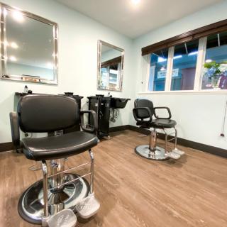A well-equipped hair salon with chairs and mirrors ready for customers.