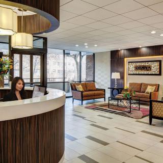 A modern lobby with a reception desk and a comfortable waiting area.