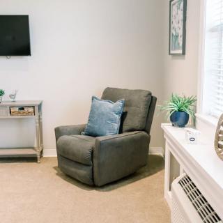 A cozy living room with a comfortable armchair and decorative elements.