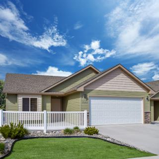 A charming suburban home with a manicured lawn and a welcoming entrance.