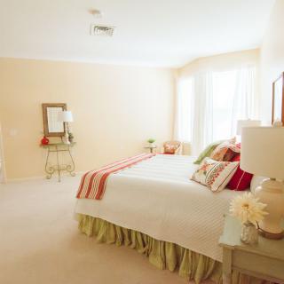 A bright and spacious bedroom with elegant decor and ample natural light.