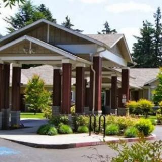 A well-landscaped building entrance with a covered driveway.