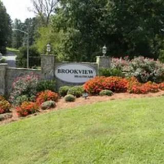Entrance sign with vibrant landscaping at a residential area.