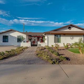 A suburban house with a landscaped front yard and driveway on a sunny day.