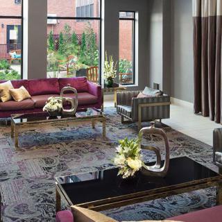 A luxurious modern living room with elegant furniture and large windows overlooking a garden.