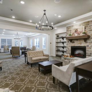 A cozy living room featuring comfortable seating, a fireplace, and elegant interior design.