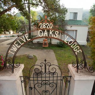 Entrance gate to Twelve Oaks Lodge with an archway sign.