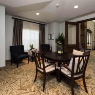 A cozy living room area with a round table and chairs, showcasing elegant decor.
