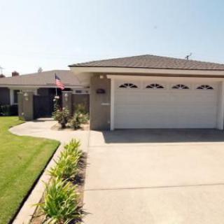 A suburban house with a two-car garage and well-maintained lawn.