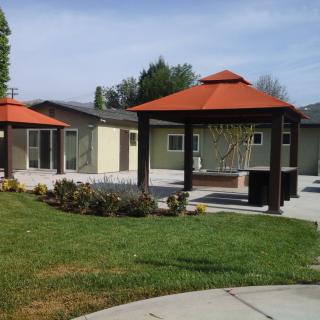 A residential backyard with a gazebo and well-maintained lawn.