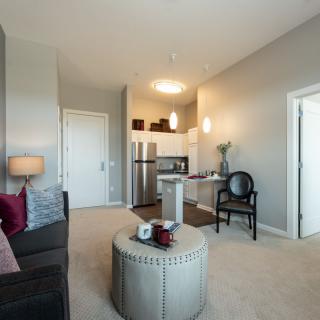 A modern apartment with an open concept living room and kitchen.