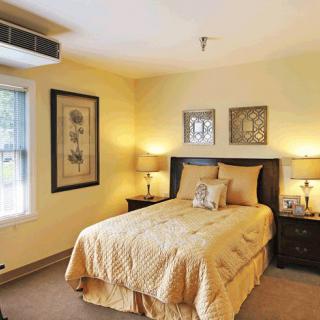 A cozy bedroom with elegant decor and warm lighting.