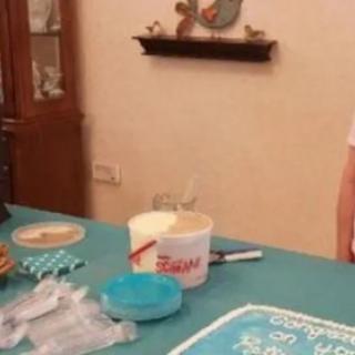 A kitchen setup with baking items and a decorated cake.