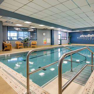 An inviting indoor swimming pool area with comfortable seating, perfect for relaxation and leisure activities.
