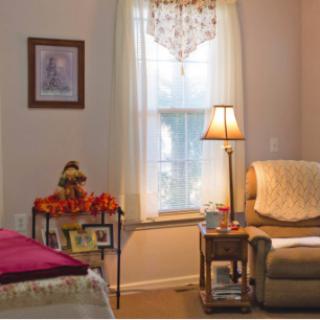 A cozy living room with soft furnishings and warm lighting.
