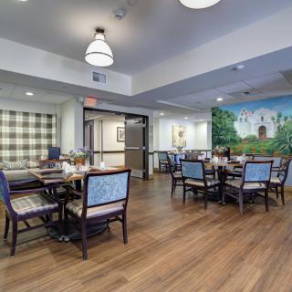 A spacious and well-decorated dining room with wooden floors and comfortable seating.