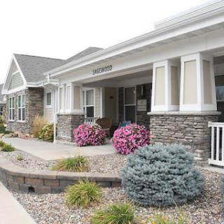A charming residential building with well-maintained landscaping and vibrant flowers.