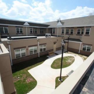 A view of a school building with a courtyard and pathways.