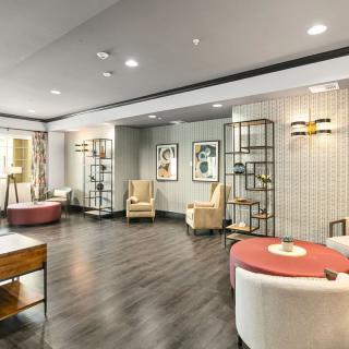 A modern living area with stylish furniture and decorative lighting.