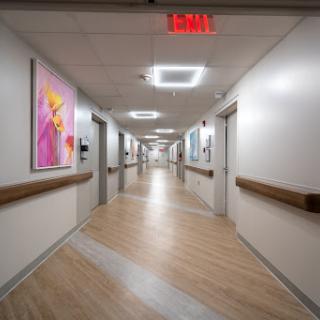 A well-lit and modern hospital hallway adorned with colorful artwork.