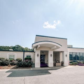 A welcoming entrance to a well-designed building under a clear blue sky.