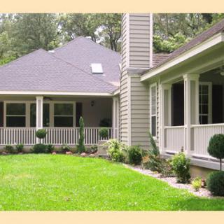 A charming house with a well-maintained lawn and inviting porch.