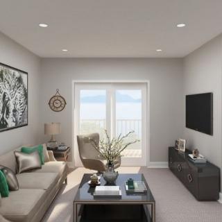 A modern living room featuring a comfortable sofa, stylish decor, and a wall-mounted TV.