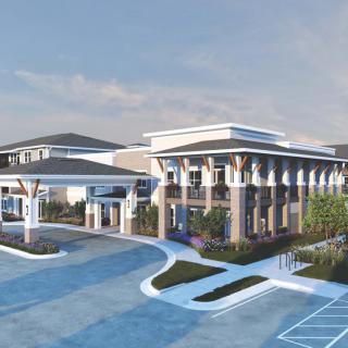 A modern architectural building with a landscaped driveway and contemporary design elements.