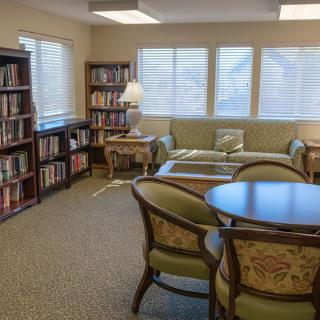 A cozy reading room with bookshelves and comfortable seating.
