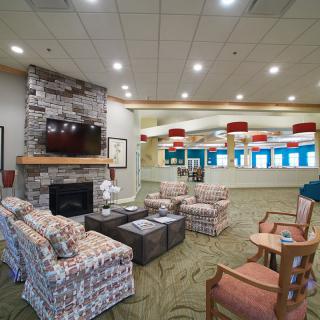 A cozy living room interior featuring a fireplace, television, and comfortable seating area.