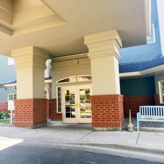 Entrance to a building with brick and column architecture.