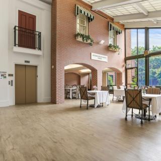 A spacious and modern dining area with large windows allowing natural light to fill the room.