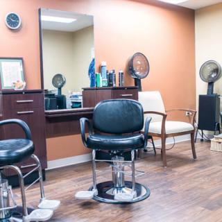 A tidy barbershop interior with styling chairs and mirrors.