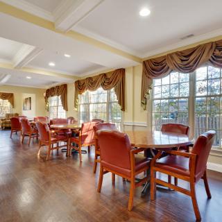 Spacious dining room with elegant furnishings and large windows.