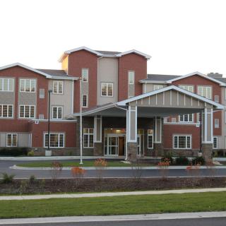 A modern healthcare facility with a brick exterior and large windows.