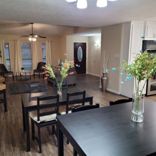 A spacious open-concept living and dining area with modern furnishings and wooden flooring.