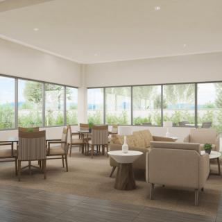 A modern lounge area with ample natural light and comfortable seating.