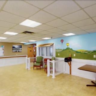 A welcoming community space featuring colorful murals and comfortable seating.